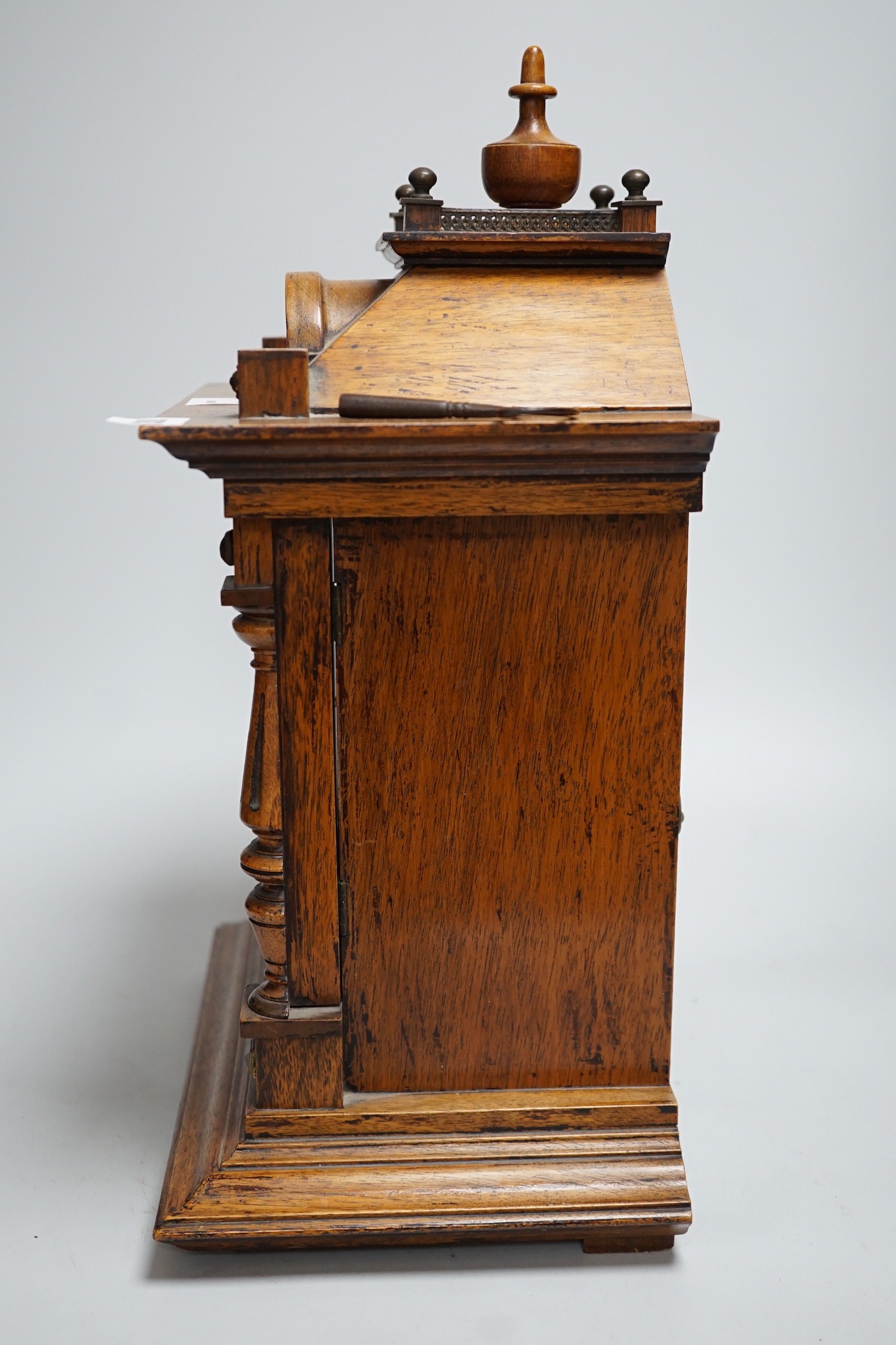A German oak cased clock, plaque reads ‘Presented to Harry Collins on the occasion of his marriage by the members of Bradford House May 1st 1897’. Height 40cm